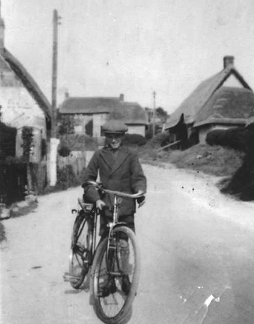 I don't know who the boy with the bicycle is but the picture is looking up Enford Hill and clearly