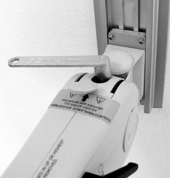 If necessary unlock and readjust the Arm until the Counterbalance Adjuster bolt is accessible through the Adjuster Cover (below center). Lock Arm when Counterbalance Adjuster is accessible. 3.
