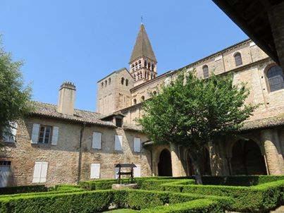 It has the 11th century abbey church of St Philibert (here the cloister garden).