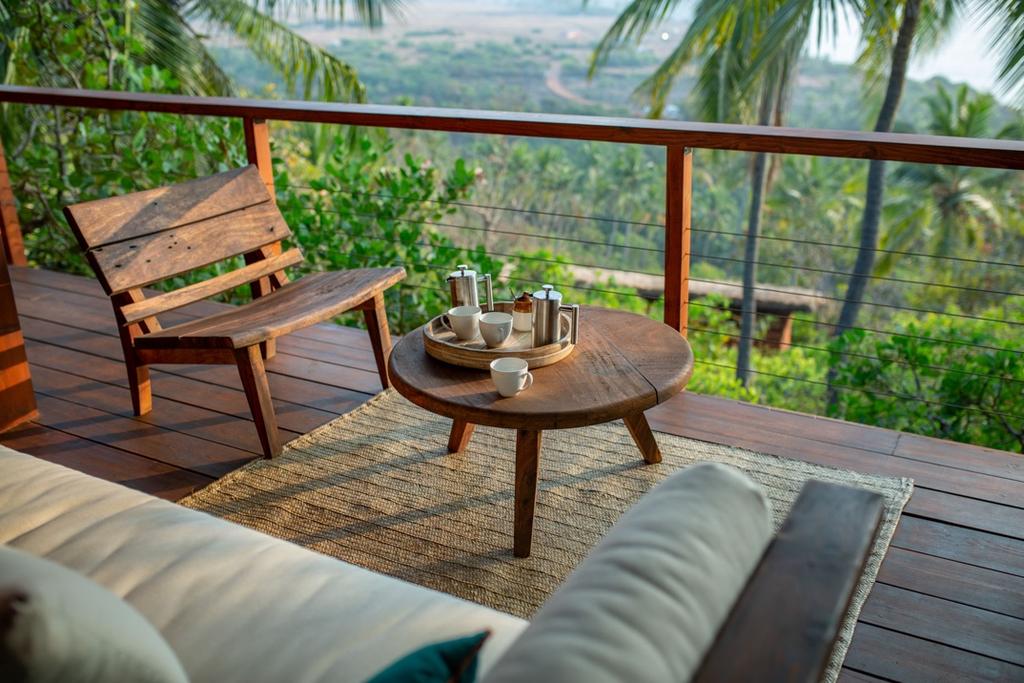 Each cottage comes with an expansive deck balcony perched over lush greenery, looking out