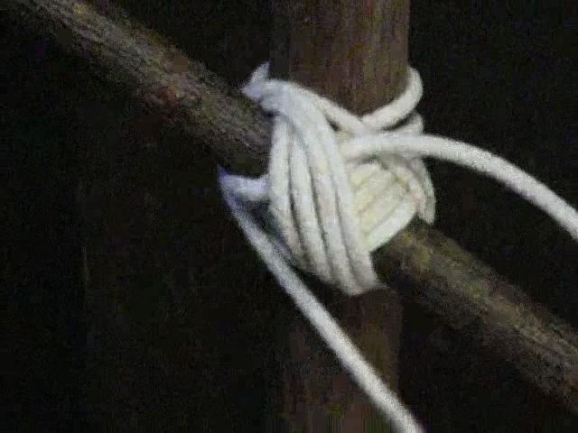 Make a clove hitch around both sticks where they cross, again leaving