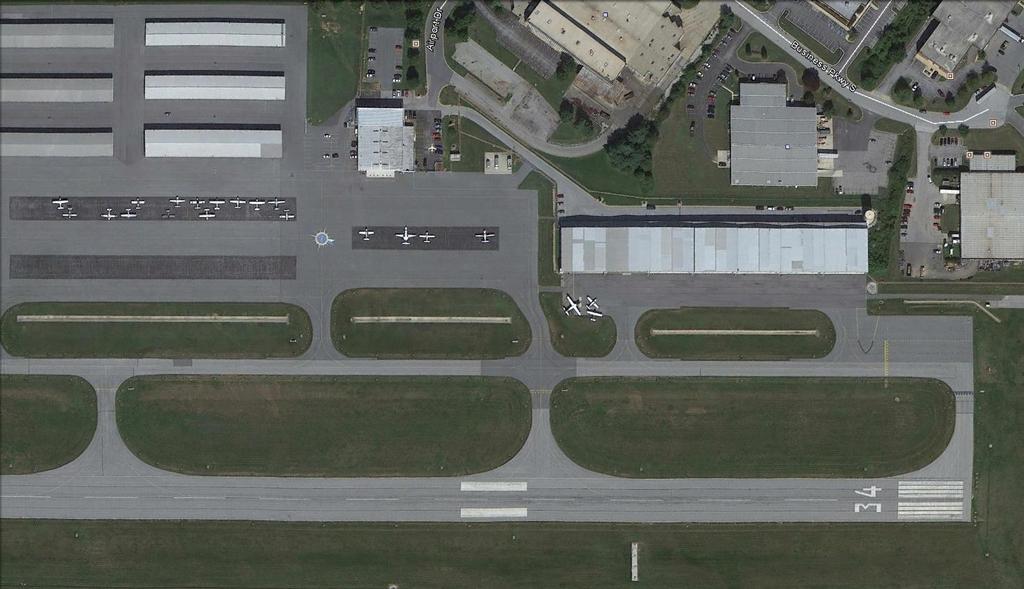 Chapter Four FAA DESIGN STANDARDS REVIEW Figure 4-3: Entrance Taxiway at DMW Source: Google Earth B) Apron Layout Apron locations that allow direct access onto a runway are not recommended.