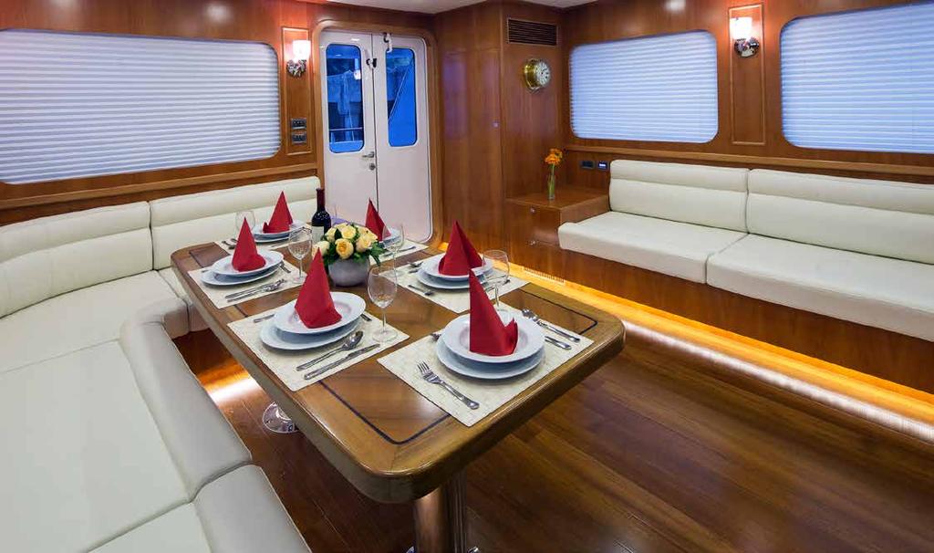 The saloon features built-in seating on both sides with a large dinette to starboard.