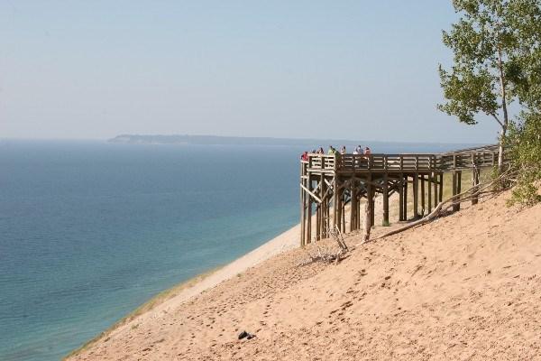 Lake Michigan Overlook Observation Deck with South Manitou Island in the background. Look at Lake Michigan. Notice the shades of blue caused by the varying depth of the lake along the shoreline.