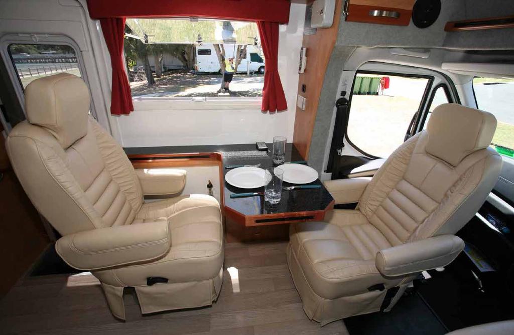 54 Day Test Living Area Both cab seats swivel and are reupholstered to match a third, forwardfacing seat behind the passenger seat (there s a folding table in between).