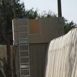 (Shown in photo below) Ladder with Walk Through Ladder attached on non-threat side of Guard Tower on one side of Walk Through opening in wall.