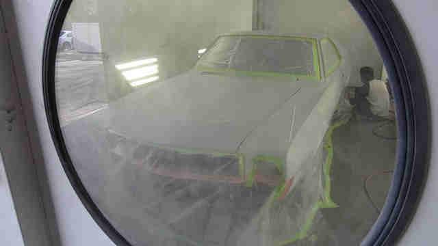 Early in the morning we had the car flat bedded over to the paint booth in Temecula, where the car finally got painted! Awaiting her beauty treatment.