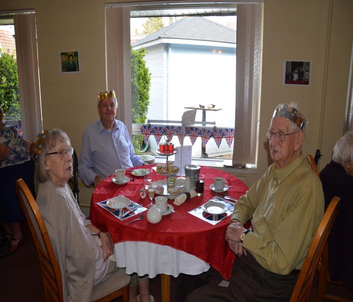 Residents put on hand made paper crowns which