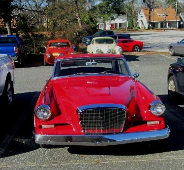 Studebakers shown like Christmas ornaments in the bright sunlight.
