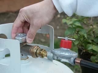 Open the propane valve (turn counter-clockwise as viewed from above) slowly, for about one turn (360 degrees). Caution!