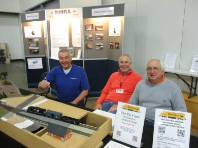 DIVISION 8 AT 2019 GREAT TRAIN SHOW. Above: Bob Kuchler, Bob Frankrone, and Rick Maloney. Right: Don Fowler introduces a young man to operations on the Division 8 Demonstration module.
