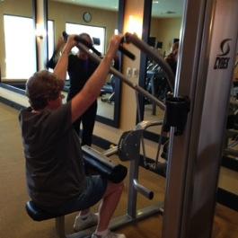 Pull Down Arm Curl (or Bicep Machine) This machine targets the lat muscles and works you trunk muscles for good posture.