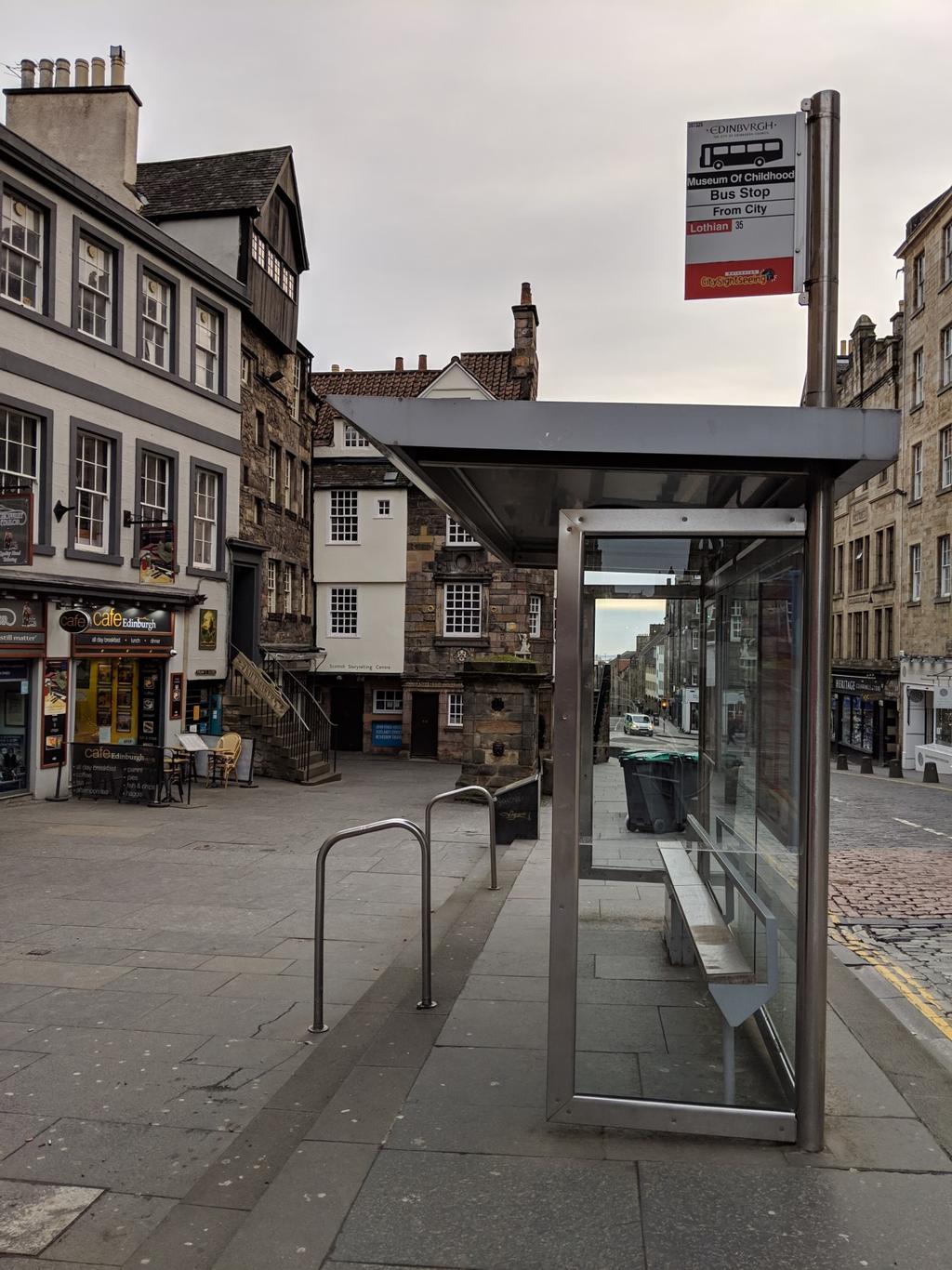 The photo shows the level access alternative to using steps at this bus stop.