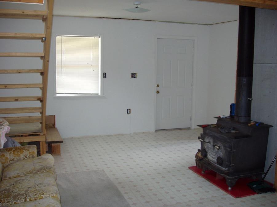 This is the view back toward the south-facing porch. The bathroom is to the right behind the wood stove.