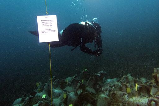 Ancient shipwreck to be made accessible to divers in Greece 9 April 2019, by Elena Becatoros In this photo taken on Sunday, April 7, 2019, an archaeologists dives next ancient amphoras from a 5th