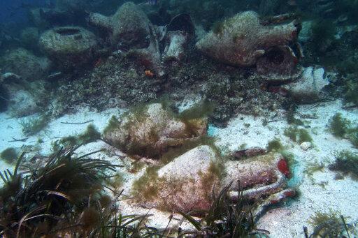In this photo taken on Sunday, April 7, 2019, archeologists and visitors prepare to dive to a 5th In this photo taken on Sunday, April 7, 2019, ancient amphoras lie at the bottom of the sea from a