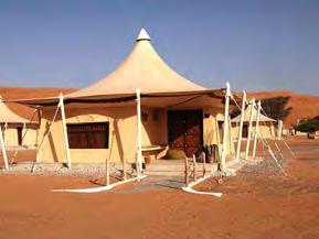 The stay includes a short camel ride within the camp and a 4x4 transfer to the summit of the nearest dune for sunset. The Deluxe Suites (37 m²) have a small sitting area.