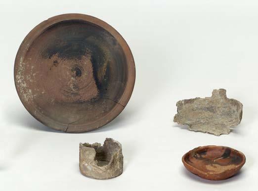 130 catalogue Figure 56. Pyre 24, 325 300? Back row: P 22988 (plate), IL 1280 (lamp holder). Front row: IL 1281 (lead pyxis), P 22987 (saucer). Fragments of four uninventoried saucers not illustrated.