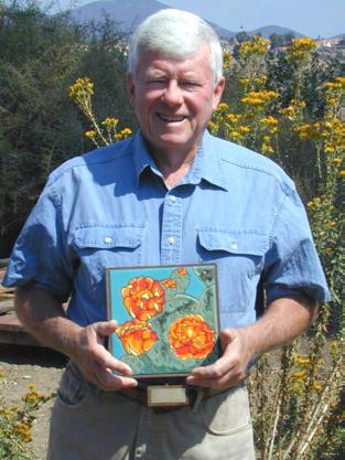 Kelly Receives Restoration Award Mike Kelly, the Friends' Conservation Chair, is pictured holding a beautiful, handcrafted tile plaque (depicting a native prickly pear plant), awarded him by the
