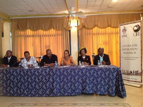 Olivia Grange addressing the audience at the October 12 Press Conference. Seated (L-R) are: Dr Eric Phillips, Chair, NCR, Guyana; Hon.