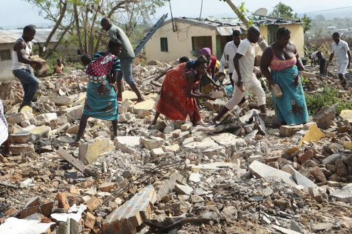 Cyclone Idai's death toll now above 1,000 in southern Africa 10 April 2019, by Farai Mutsaka Women and men pick up bricks from a collapsed house to build another structure in Beira, Mozambique,