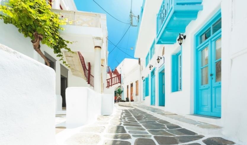 Explore the narrow marble streets and admire the whitewashed houses with their colourful doors and windows, framed with