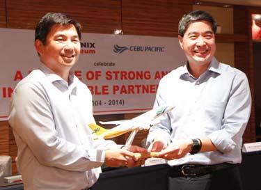 Phoenix Petroleum Philippines President and CEO Dennis Uy (left) receives a diecast model of a Cebu Pacific Aircraft