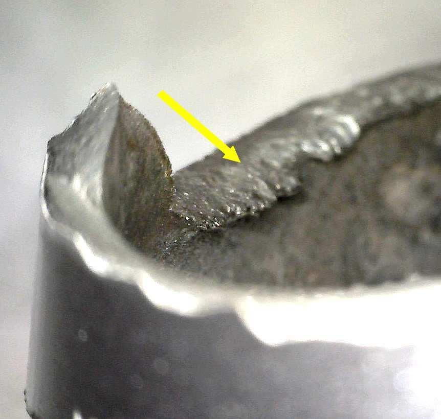 fracture, but that they were caused by sliding of a solid hard object along this part of the fracture surface.