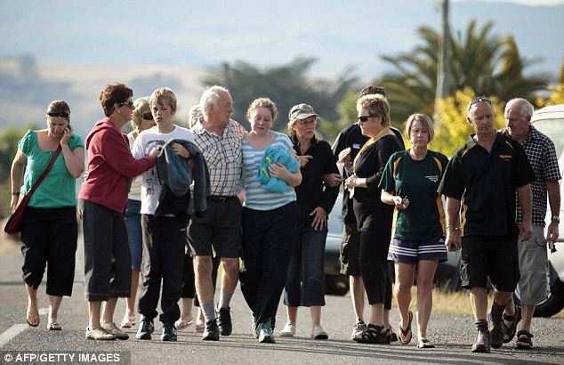 Shock: Relatives and friends in grief at the scene of the crash.