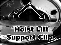 Put the steel hoist lift support located on the end of the cable through the rim of the tire. The hoist lift support clips need to seat inside the center hole of the tire rim.