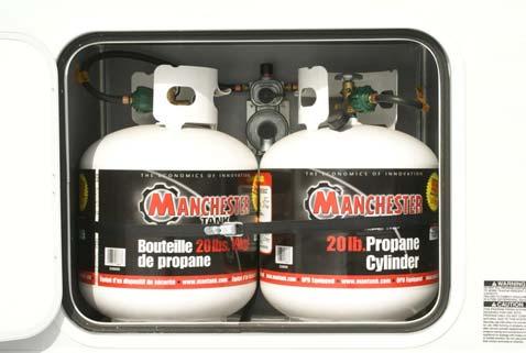 SECTION 8 PROPANE SYSTEM INSTALLING PROPANE CYLINDER(S) Ensure that all straps and fasteners are secured before traveling. Double Cylinder Mounted in Compartment Fig. 8.6 Double cylinder 1.
