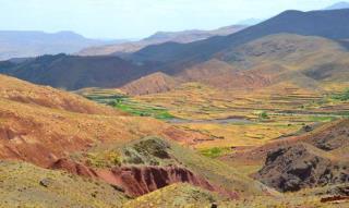 Beautiful panorama of Draa river valley Terraced farmland with carpets drying by the river.