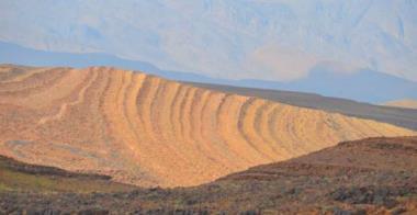 Strata tilted, eroded and now caressed by the sun to create a glorious pattern. The High Atlas Mountains are behind.