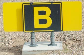 black lettering. This sign shows Taxiway Bravo is to the right.
