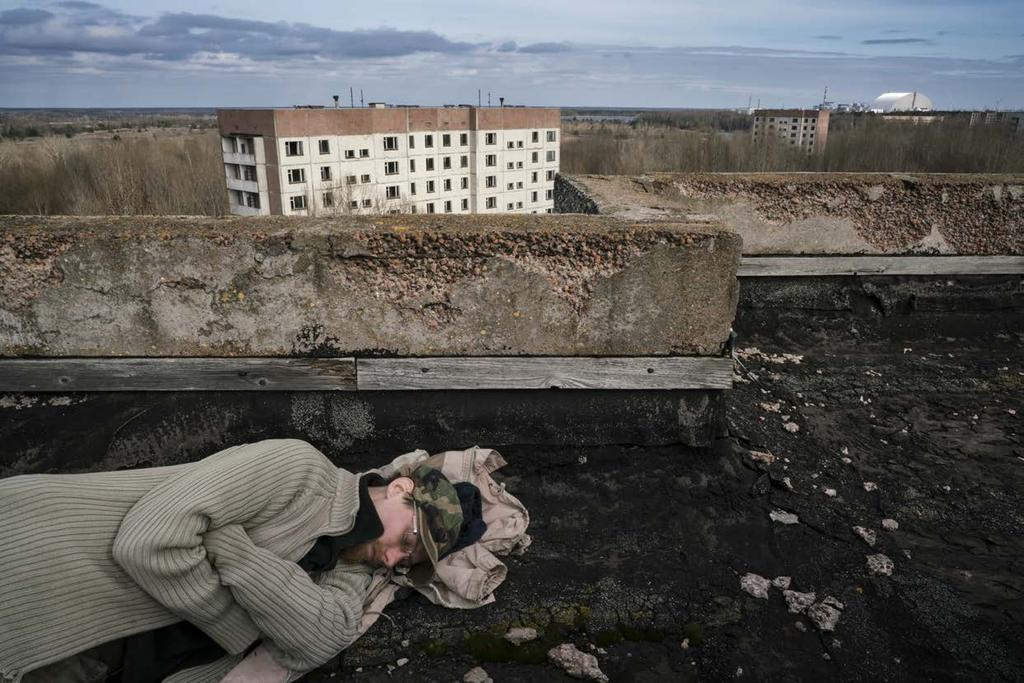 Sasha sleeping on the roof of a building in the ghost town of Pripyat.