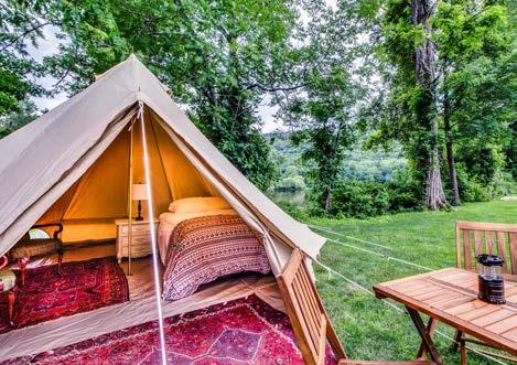 The tent also includes side tables, a lamp, alarm clock, coffee maker, and accompanying items, a lantern, a fan, a heater, and a table. Is everyone camping in the same area?