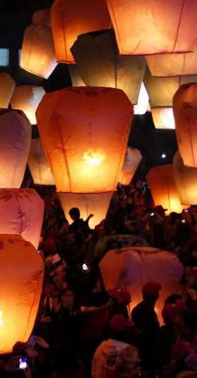 People write their wishes on fire lanterns and release them into the sky en masse,