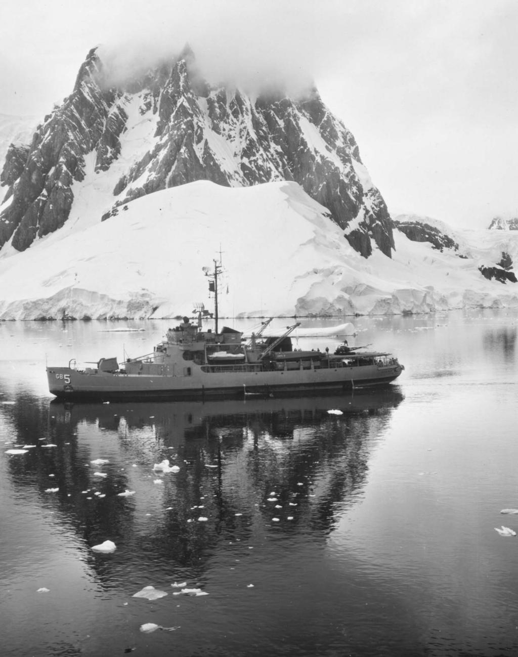 Background, the icebreaker Staten Island (AGB 5) with an HUL-1 helicopter on board approaches the Palmer Peninsula during Antarctic operations in April 1963. Facing page, inset, Cdr. Richard E.