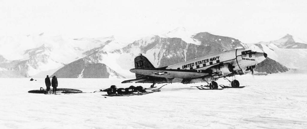 Above, the R4D Que Sera Sera idles next to its refueling tanks at Beardmore-Scott Auxiliary Air Base. Left, the crew of Que Sera Sera at the South Pole on 31 October 1956. From left: AD2 John P.