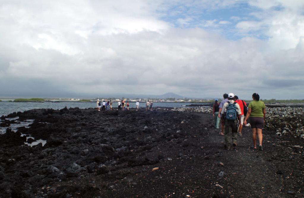 Photo 3. Visitors at the Tintoreras visitor site, Isabela. Photo: Christophe Grenier animals in the towns, especially lava lizards, marine iguanas, and finches.