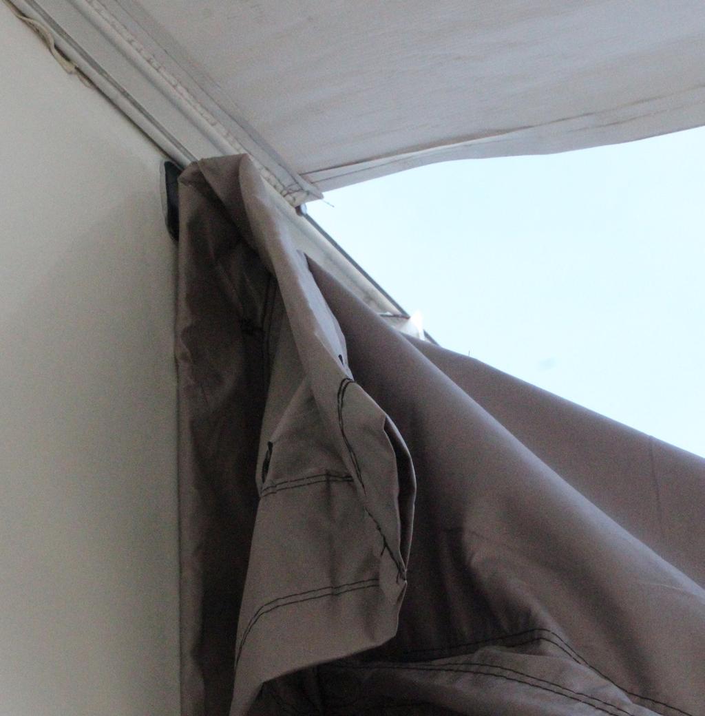 1A) directly under the awning rail so the hook is approximately 2 under the awning fabric and the end of the bottom of the L portion of the bracket is directly under the edge of the awning fabric
