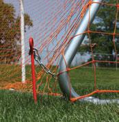 Chain link wraps anchor pin inside ground sleeve and rear spreader tube on surface to secure goal in place. Padlocks included.