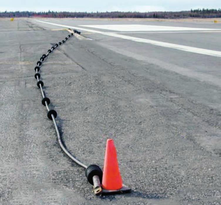 Figure 8: Disconnecting an arresting cable In some situations, an arresting cable can simply be disconnected and laid on the side of the runway during periods of commercial operations.