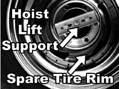 Place the tire on the tire carrier with the top lug bolt inserted into one of the holes in the tire rim and the bottom lug bolt in the center of the rim. 2. Install the top lug nut. 3.