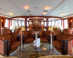 The restaurant seats all passengers in one sitting and is located on the Emerald Deck.