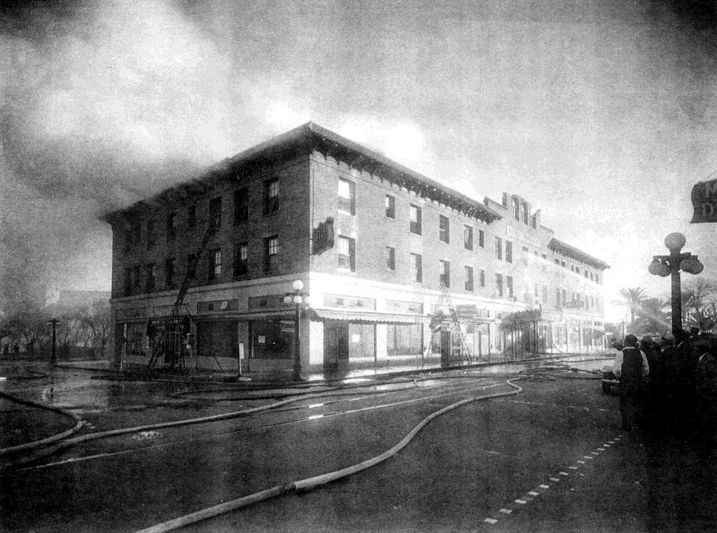 Firefighters stream water into the third floor of the Hotel Congress from Toole Avenue.