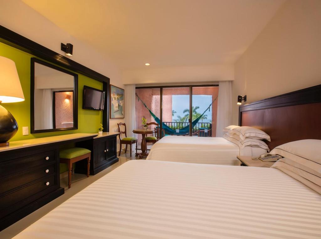 Rooms DELUXE WITH SEA VIEWS In addition to the comfort and convenience that guests expect, these rooms boast spectacular views of the bay from their private balcony or terrace.