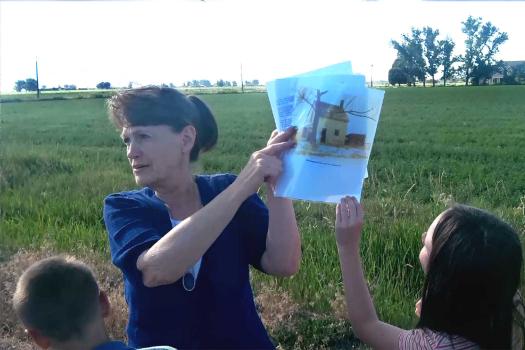 Showing a photo of the missing family farm house while standing in front of the location makes it easier to visualize where the house stood (above).