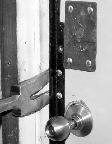 ) Place the fork (bevel to door) between the angle iron and the door frame, six inches above or below the lock. (See Figure #2.