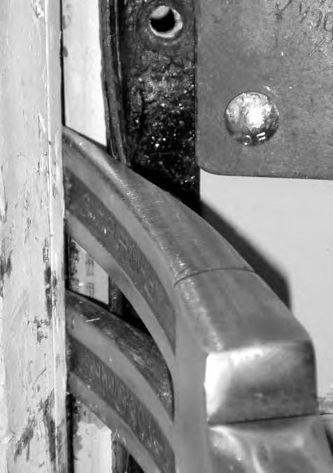Figure #2--Place the fork (bevel to door) between the angle iron and the door frame, six inches above or below the lock.
